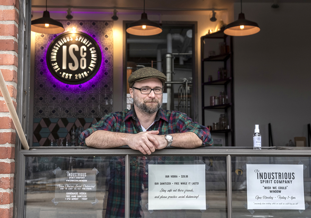 ADAPTING: Liam Maloney is a tasting room manager at The Industrious Spirit Co. The Providence company is offering free hand sanitizer it makes from the byproduct of vodka manufacturing. / PBN FILE PHOTO/MICHAEL SALERNO